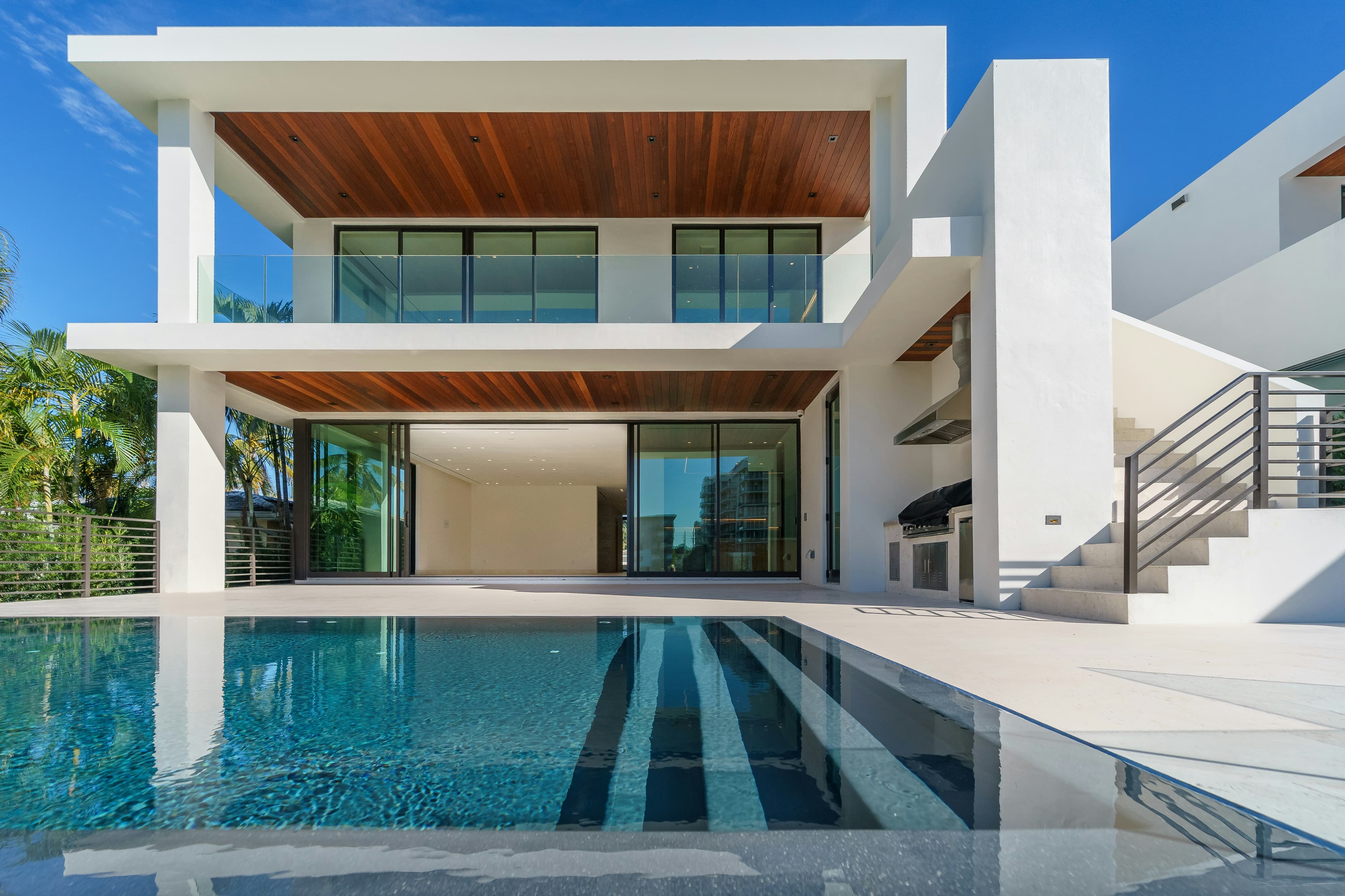 Luxury home with a pool at dusk